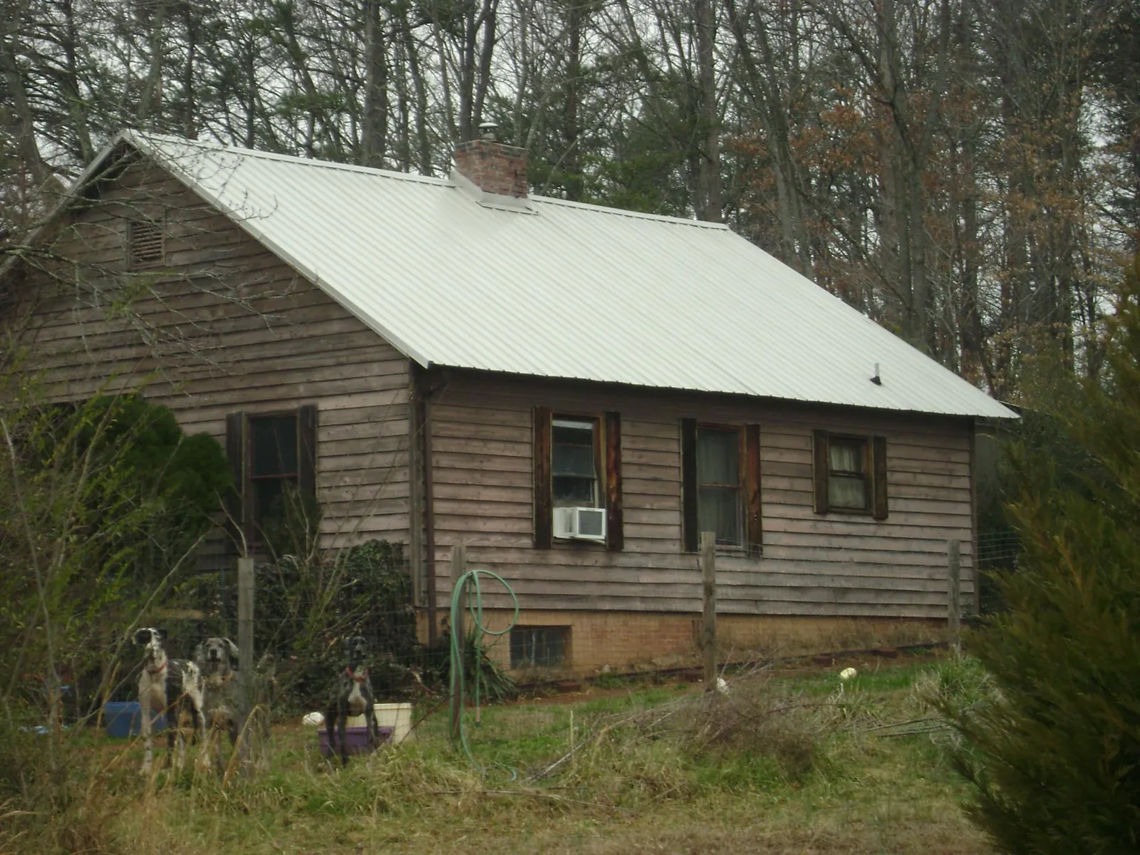 White metal roof on an old wood sided farmhouse, from a Metal Roof Installation job in Chesterhill